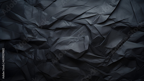 Black crumpled paper texture background 