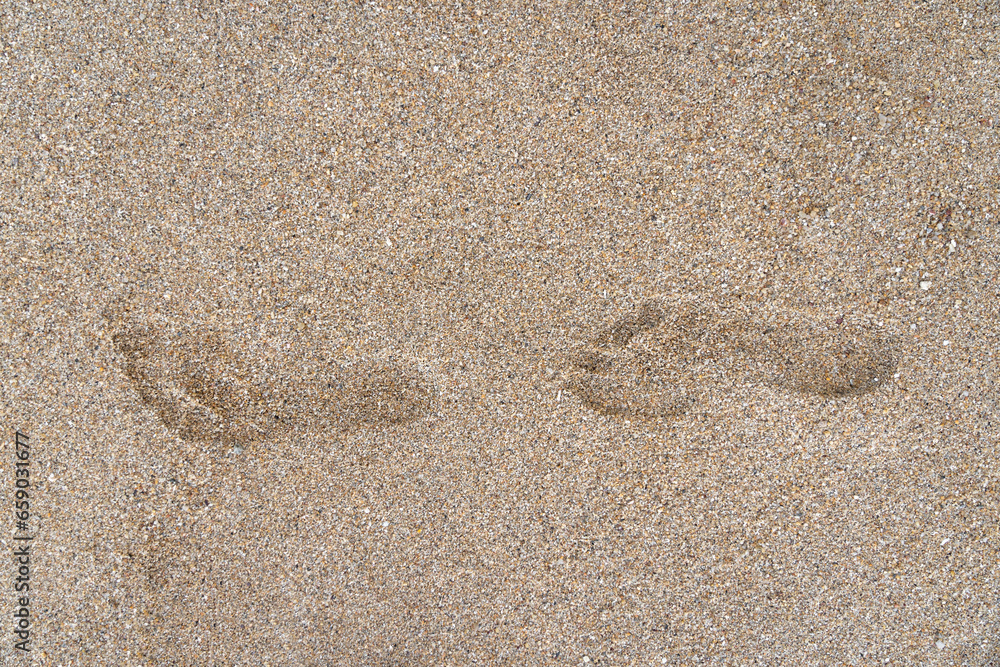 close-up shot of human footstep on the sandy beach. Minimalistic. Conceptualizes solitude, travel, the footprint of humanity on the planet's destiny, psychology, and finding solace in nature alone close-up shot of human footstep on the sandy beach. Minimalistic. Conceptualizes solitude, travel, the footprint of humanity on the planet's destiny, psychology, and finding solace in nature alone