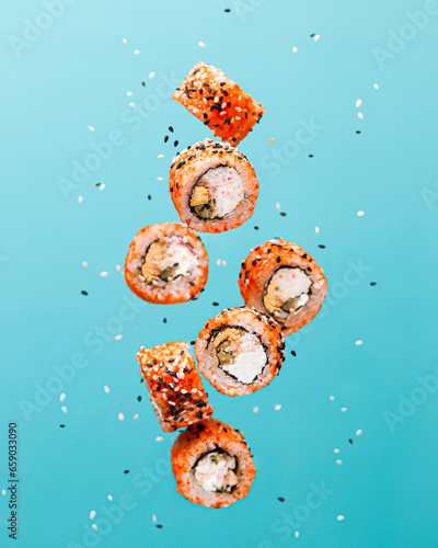 food photography of flying sushi rolls with salmon. Creative levitation concept 