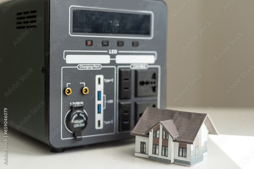 Obraz premium lithium Portable Power Station is charging laptop smartphones Power banks and other gadgets. Modern, information technology. Control panel. close up. Home