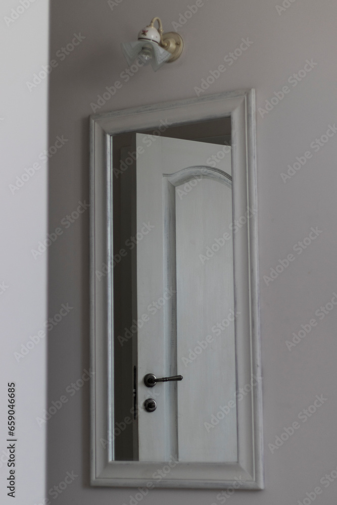 Photo of the interior door in the mirror. Photo of the interior door in the mirror.
