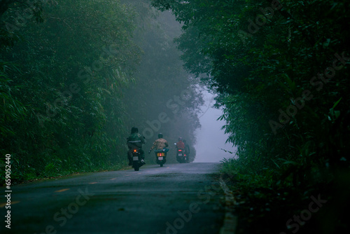group of biker riding on foggy mountain road at khaoyai national park one of most popular traveling destination in thailand