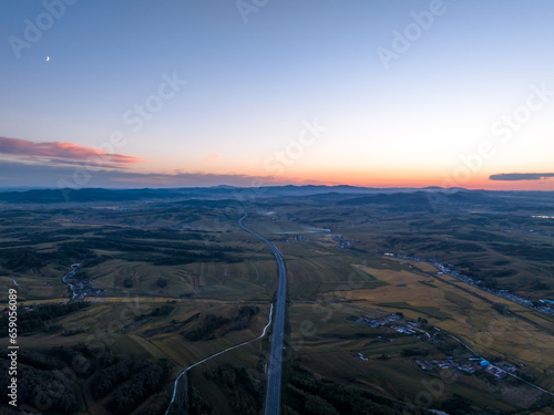 aerial view of highway in countryside at sunset