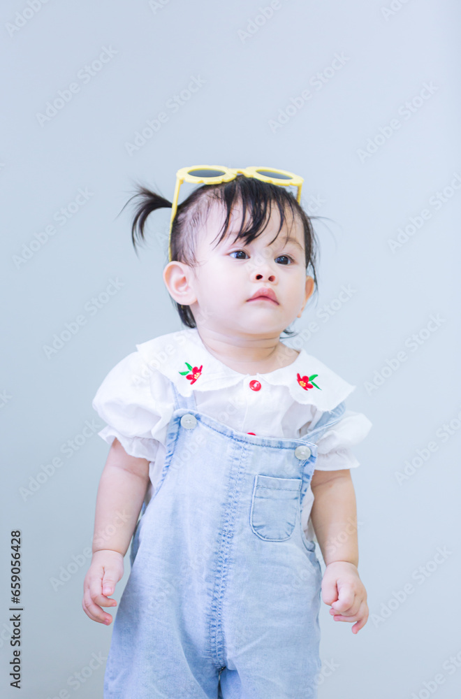 Asian girl, 1 year old,Cute asian kid in the house,Image of Asian child posing on blue background Asian girl, 1 year old,Cute asian kid in the house,Image of Asian child posing on blue background