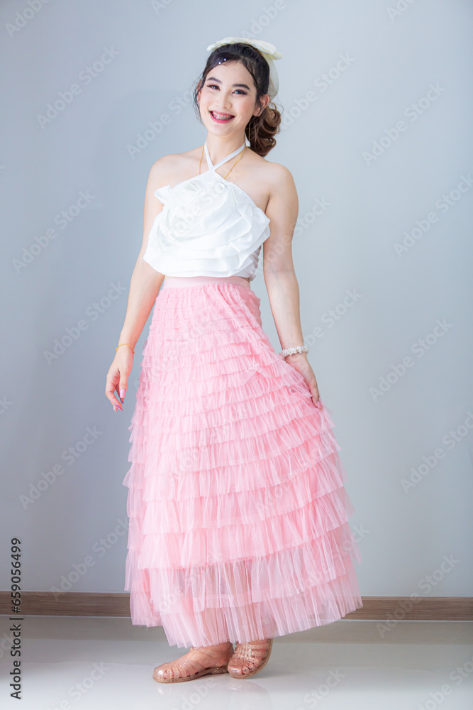 Asian woman on the background,Photo of young Asian girl on pink background,Asian woman wearing a skirt on a background Asian woman on the background,Photo of young Asian girl on pink background,Asian woman wearing a skirt on a background