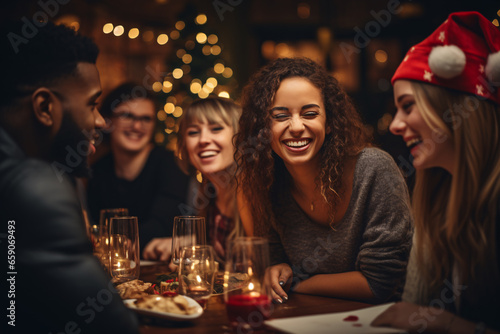 Group of young people, freinds or colleages enjoying food, drinking and talking at the party, Christmas and New year party concept. 
