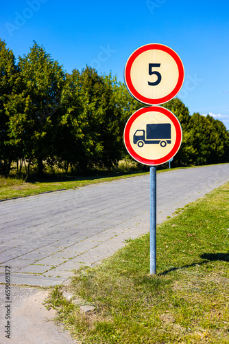 road sign limiting the speed of movement and the passage of heavy vehicles.