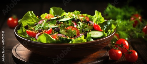 Bird s eye view of green salad in bowl on white background