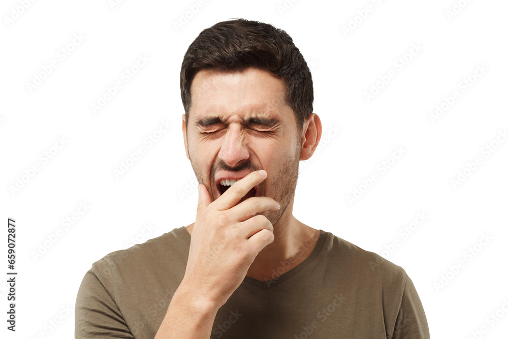 Sleepy young man yawning, waking up, closing his mouth with hand