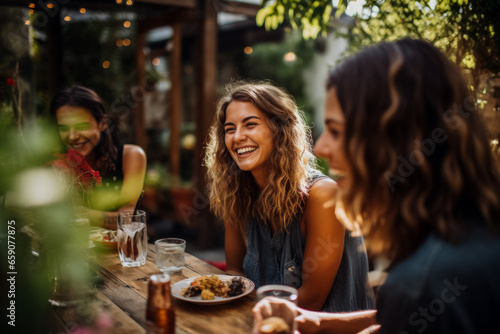Friends joyfully dine and laugh outdoors in a summer restaurant 