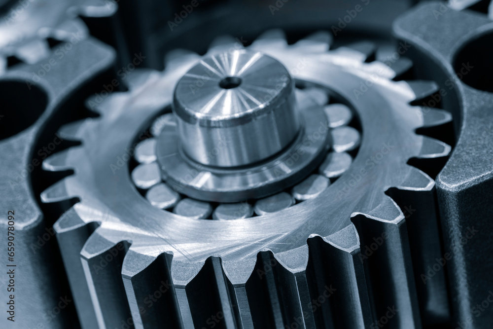 Car planetary gear with 5 satellite cog wheels in opened gearbox, industrial concept background