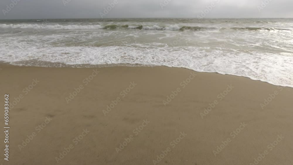 Sandy beach and ocean with waves. A beautiful white sand beach with clear blue water. Sandy beach and ocean with waves. A beautiful white sand beach with clear blue water.