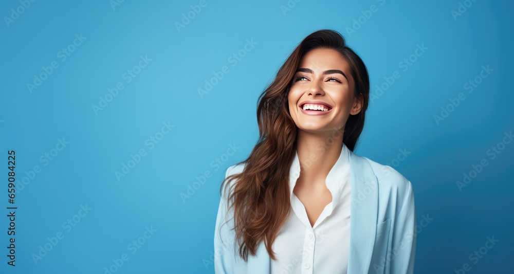Portrait of happy smiling young business woman, over blue background. Portrait of happy smiling young business woman, over blue background.