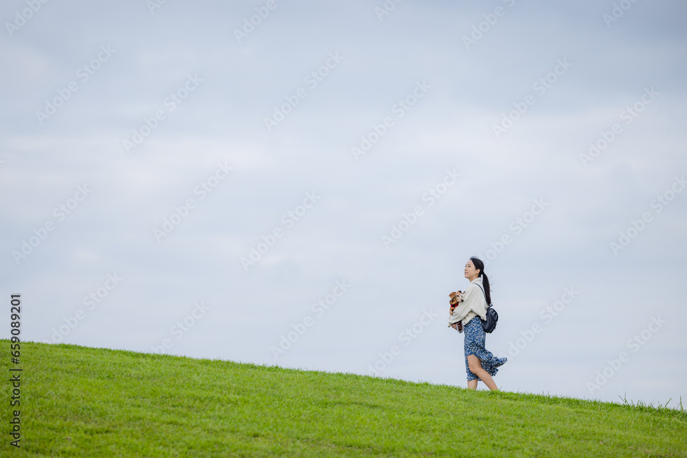 Woman with her dachshund dog walking in the park Woman with her dachshund dog walking in the park