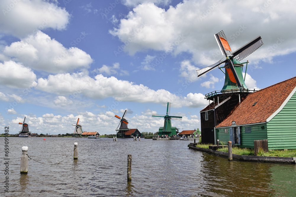 dutch windmills village seen from water, netherlands 