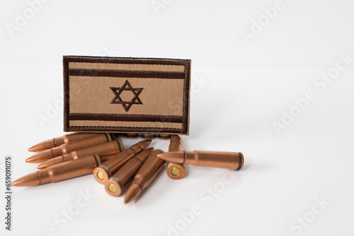 Israel flag with rifle ammunition. War between Israel and Lebanon. 7.62x39 rifle bullets ammunition. IDF military. Conflict situation and attacks. Crisis. photo