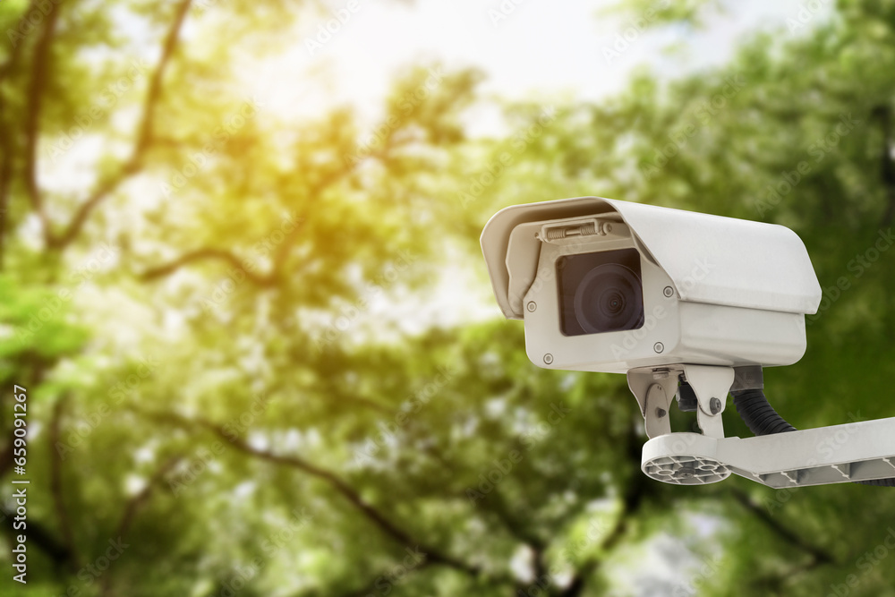 Modern public CCTV camera on a electric pole with blurred natural background. Modern public CCTV camera on a electric pole with blurred natural background.