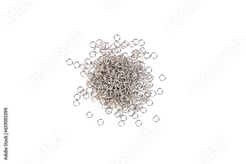 Silver colored jump rings in a pile isolated over white top down view