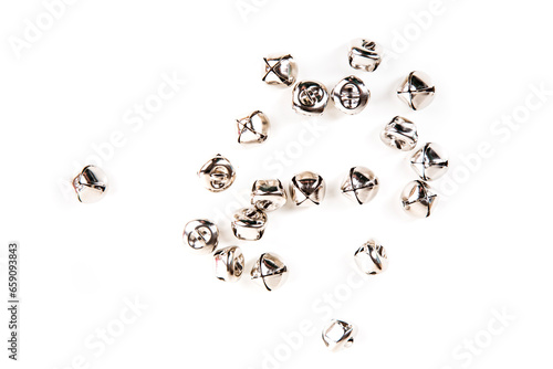 Scattered silver jingle bells isolated over white