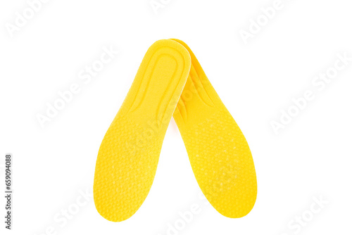 Yellow foam padded shoe inserts one crossed over the top of the other