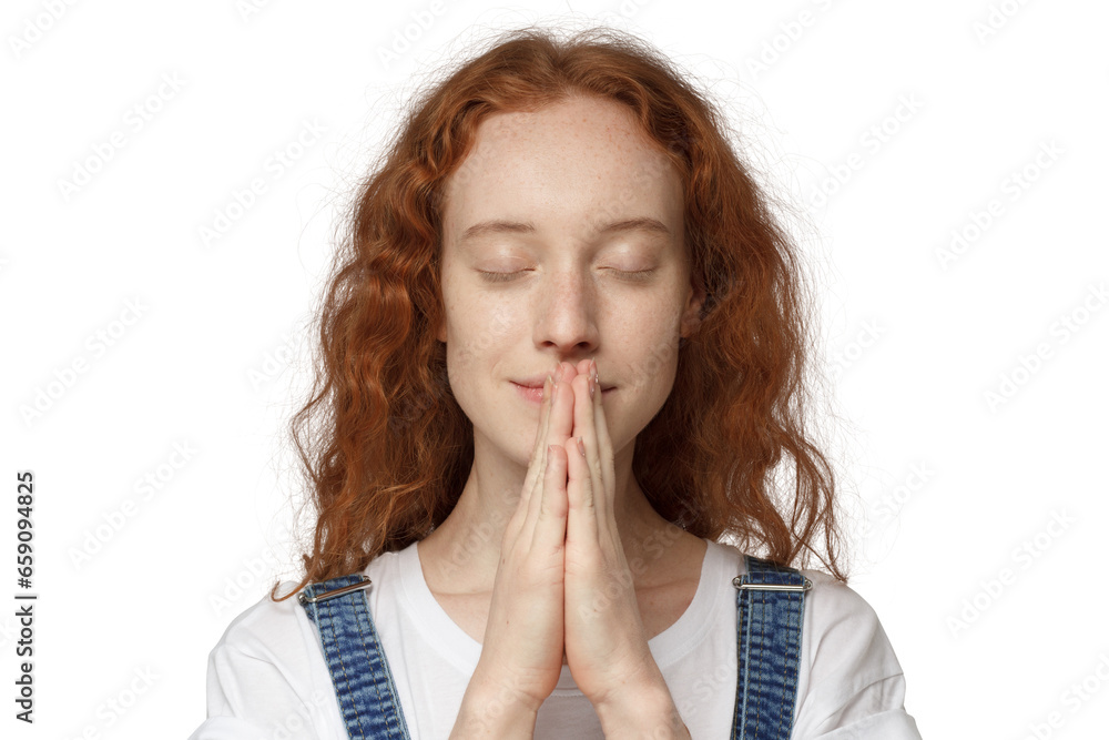Close-up of curly christian redhead girl putting hands together as if she is praying Close-up of curly christian redhead girl putting hands together as if she is praying