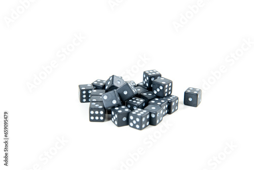 Tiny black and white dice pile isolated over white