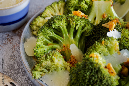 Steamed broccoli with parmiggiano reggiano cheese flakes and fried garlic.