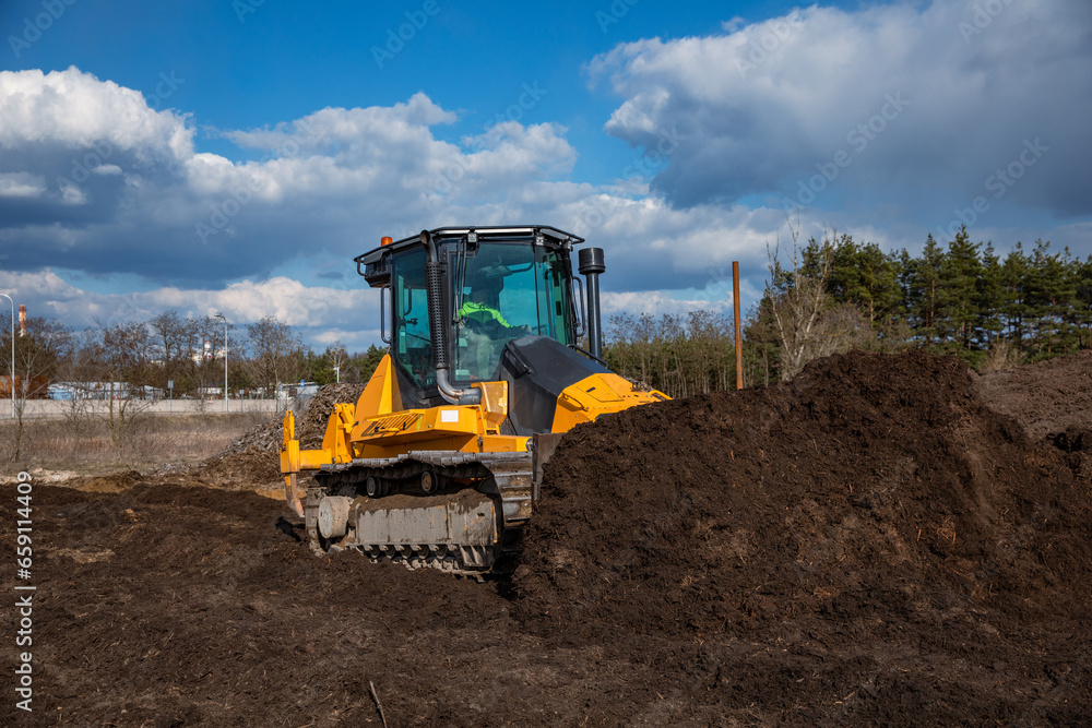 Fototapeta premium Bulldozer (crawler dozer) at work in the field.