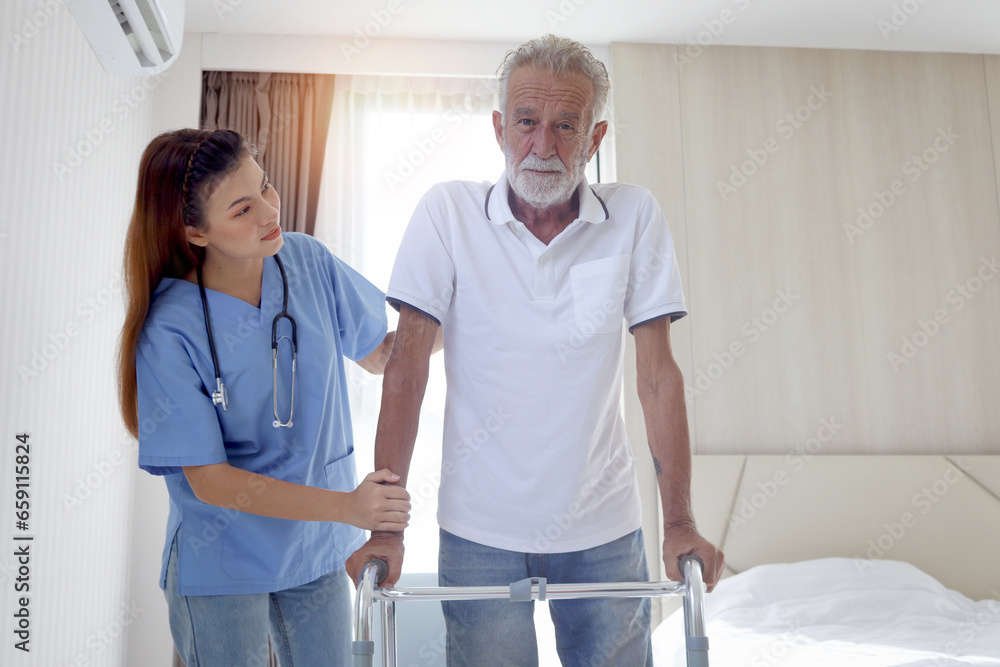 Obraz premium Female nurse or doctor helping elderly patient man lean to walk with orthopedic walker, patient practice walking inside house with physiotherapist, nursing senior people at house, medical health care.