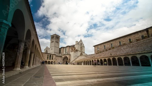 Assisi, Italy - 08 28 2023: time lapse of the papal basilica church of St. Francis one of the most famous Christian pilgrimage destinations. City of peace. Jubilee ancient tower cloud monument  photo