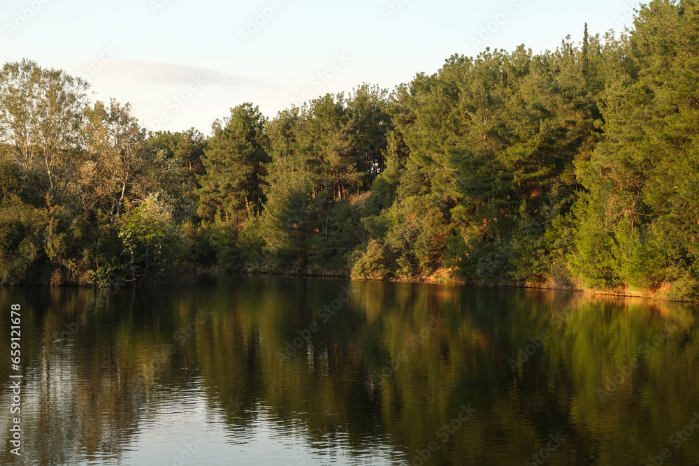 Beautiful autumn scenery. Scenic evening view of Lake and autumn forest. Colorful autumn scene of Greece, Europe. Beauty of nature concept background Beautiful autumn scenery. Scenic evening view of Lake and autumn forest. Colorful autumn scene of Greece, Europe. Beauty of nature concept background