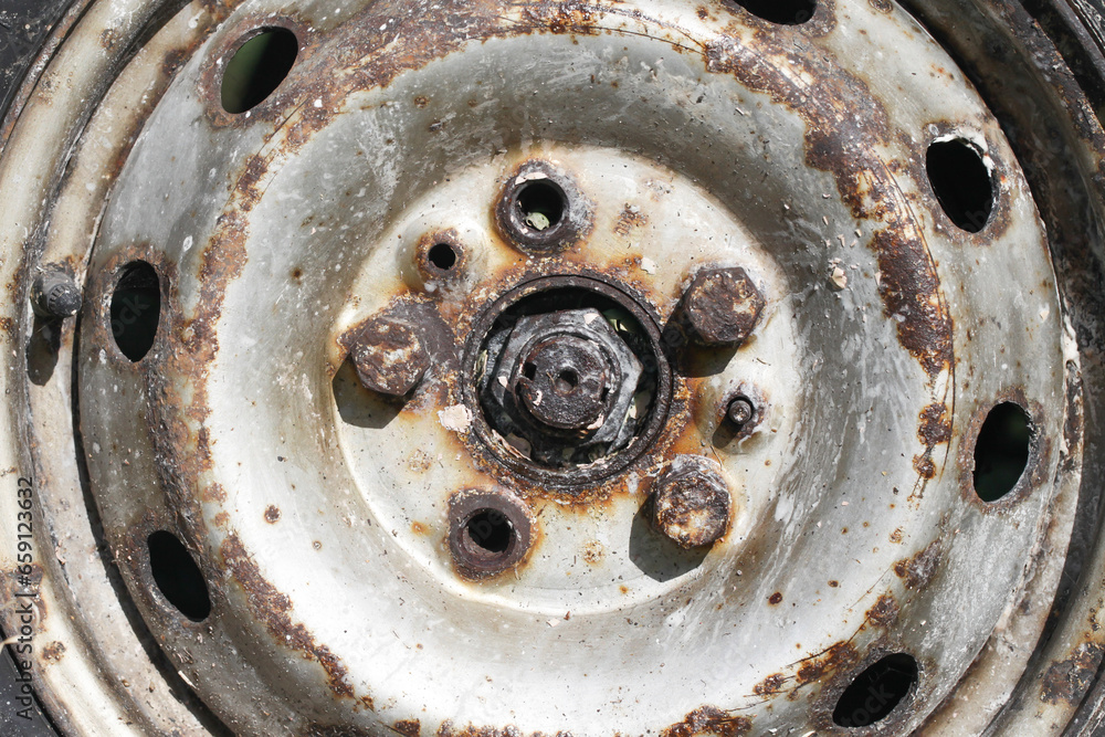 Car wheel rim. Rusty steel wheel rim. Missing bolts danger. Risk of accident. Bad condition car