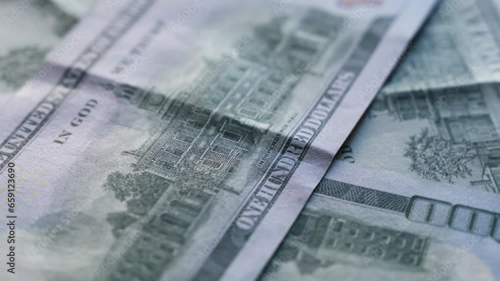 Hundred dollar bills are spinning on the table. Close-up. Business and finance concept. Hundred dollar bills are spinning on the table. Close-up. Business and finance concept.