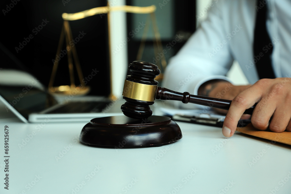 Judge gavel with Justice lawyers having team meeting at law firm in background. Concepts of law. Judge gavel with Justice lawyers having team meeting at law firm in background. Concepts of law.