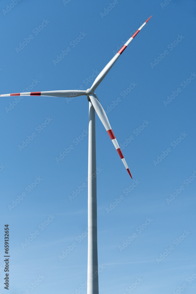 Close-up view of an electrical wind turbine, a modern marvel harnessing the power of the wind to generate clean, sustainable energy. Close-up view of an electrical wind turbine, a modern marvel harnessing the power of the wind to generate clean, sustainable energy.