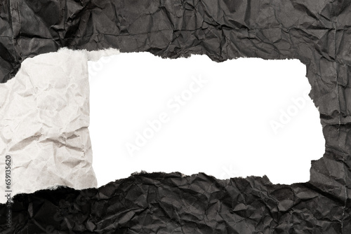 Black paper background with copy space. Hole on a crumpled dark sheet