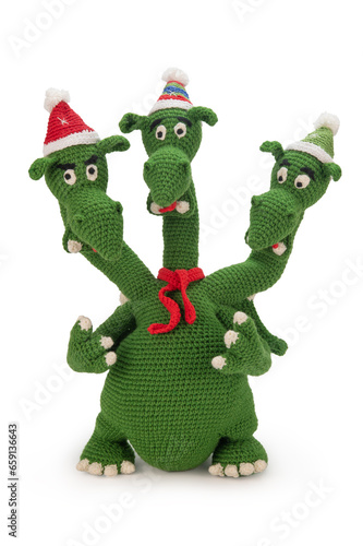 Three-headed dragon in New Year's hats and a red scarf knitted from green yarn