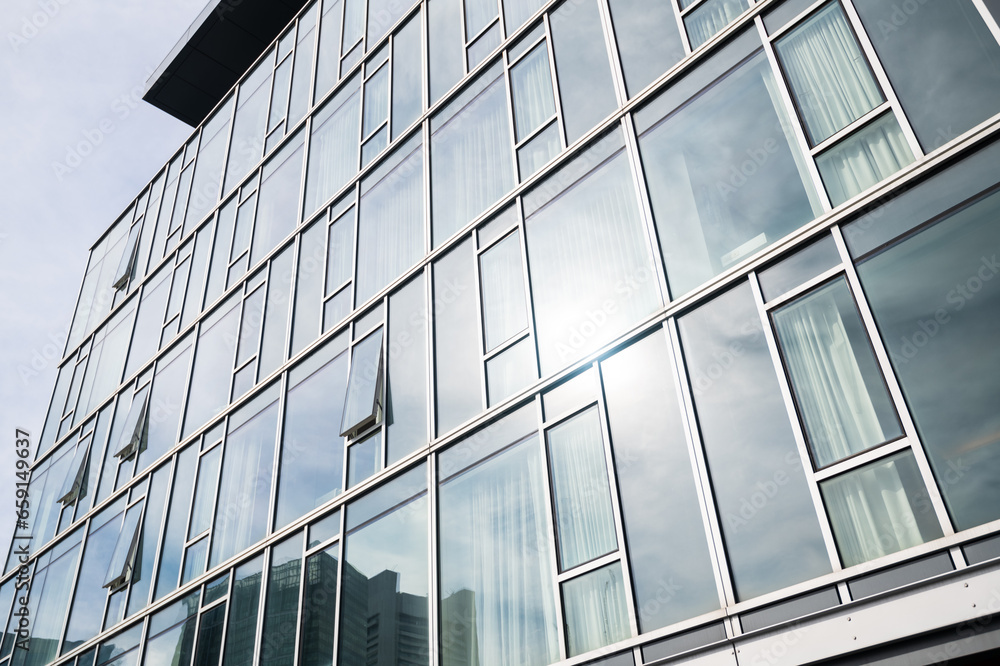 Sleek hotel and luxury apartment building background with beautiful windows and architecture. Boston Seaport business background Sleek hotel and luxury apartment building background with beautiful windows and architecture. Boston Seaport business background