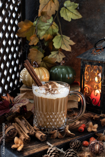 Still life with pumpkin spice latte cup on wooden background
