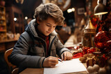 Boy writing letter to santa at christmas