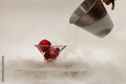 ice cream in a cup, in a white plate in a fog of liquid nitrogen six
 photo