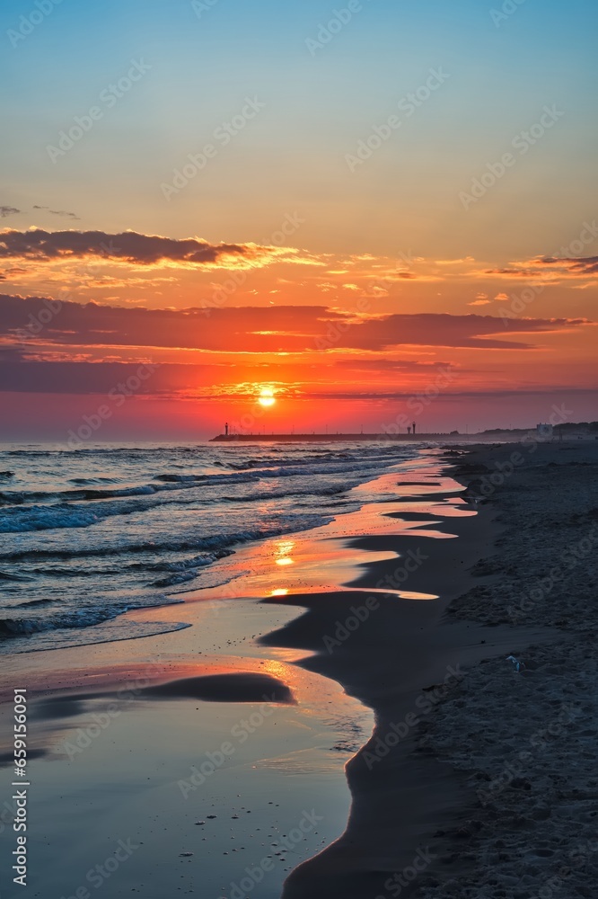 Colorful morning landscape on the Polish Baltic Sea. Sunrise on the beach in Leba, Poland.