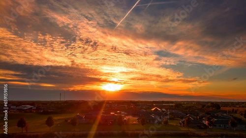 Aerial timelapse of sunset over suburban area