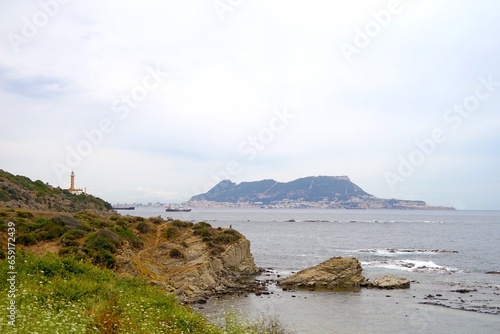 View past the lighthouse Faro Punta Carnero  to the Rock of Gibraltar, Bay of Gibraltar, Strait of Gibraltar, Spain, Mediterranean Sea, Europe