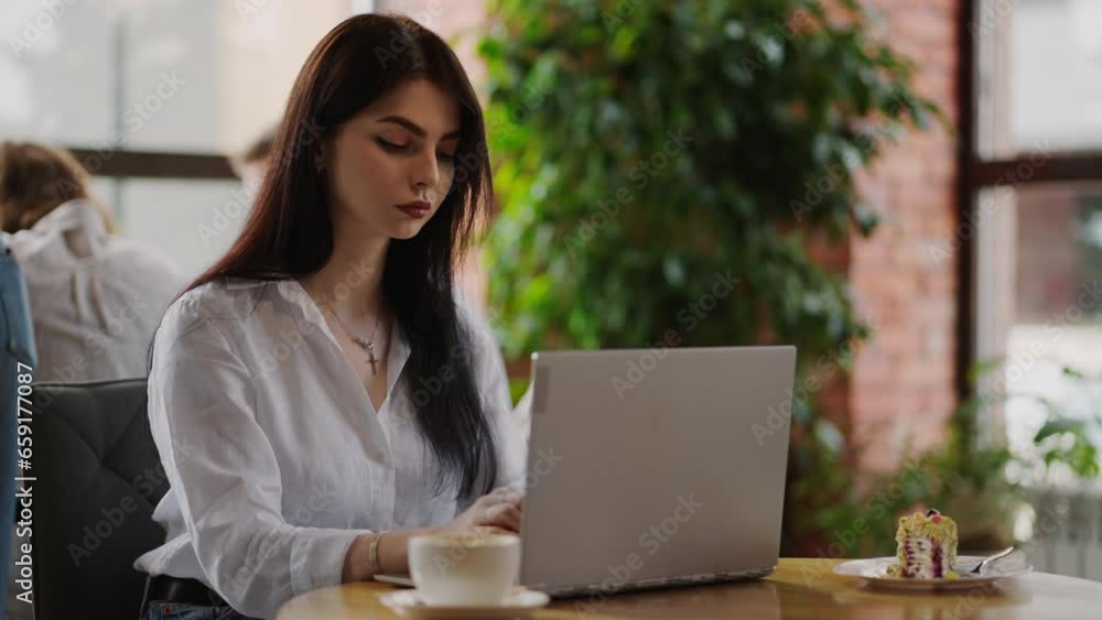 Woman Working Remotely In Cozy City Cafe In Daytime, Portrait Of Girl With Laptop Sitting At Table Woman Working Remotely In Cozy City Cafe In Daytime, Portrait Of Girl With Laptop Sitting At Table