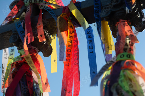 Close-up photo of souvenir ribbons tied to an iron railing in Largo Terreiro de Jesus, Pelourinho, historic center of the city of Salvador, Bahia. photo