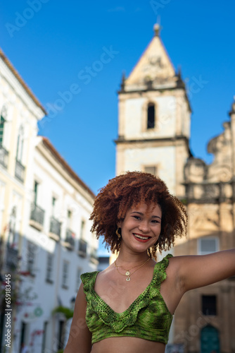Beautiful woman with red hair looking at the camera. Happy person traveling. © Thales