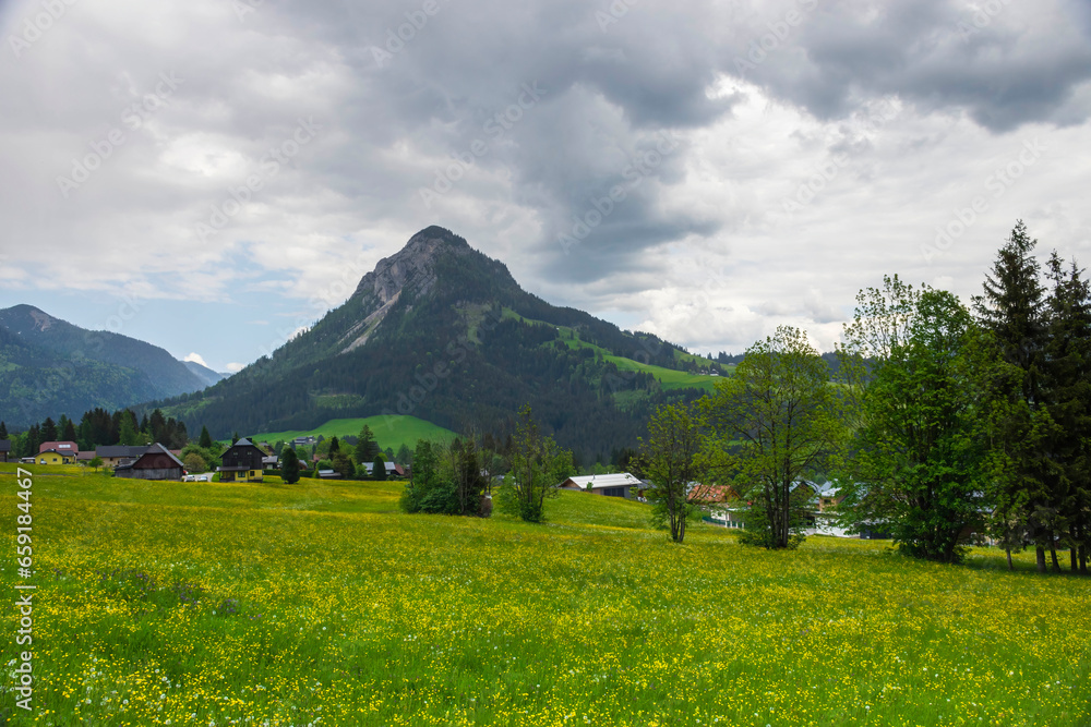Summer austrian landscape with green meadows and impressive mountains, view from small alpine village Tauplitz, Styria region, Austria