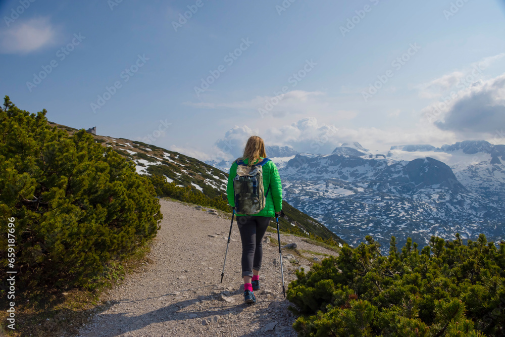 Tourist woman trekking on Mount Krippenstein in the Dachstein Mountains of Upper Austria, Salzkammergut region, Austria.