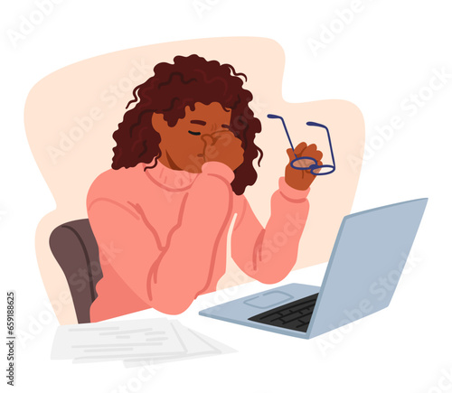Young Woman In Office Attire Sits Front Of Pc At Desk Piled With Books, Holding Glasses In One Hand Rubbing Tired Eyes